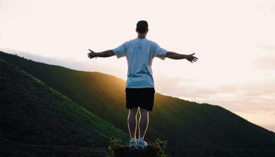 Man Standing against the Setting Sun