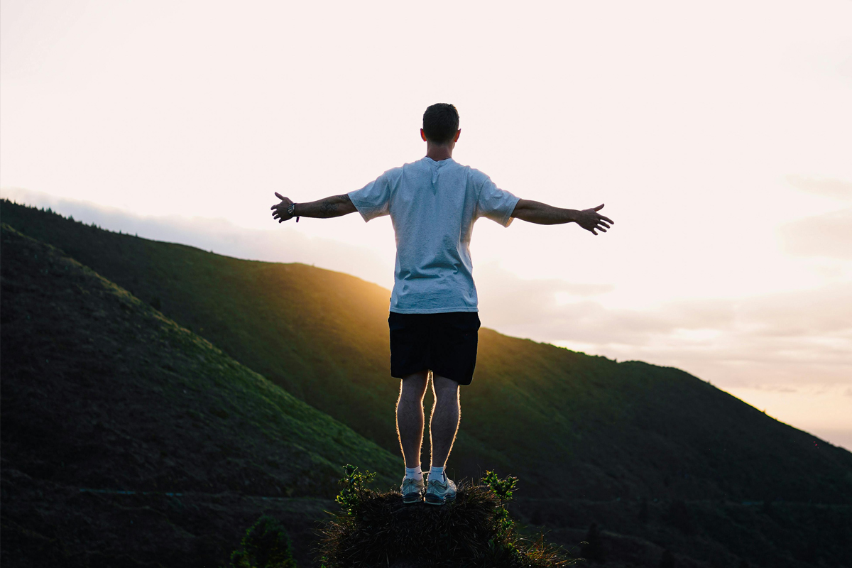 Man Standing against the Setting Sun