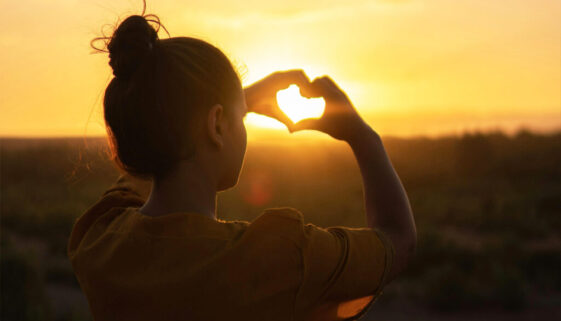 Womand doing heart shape with her hands