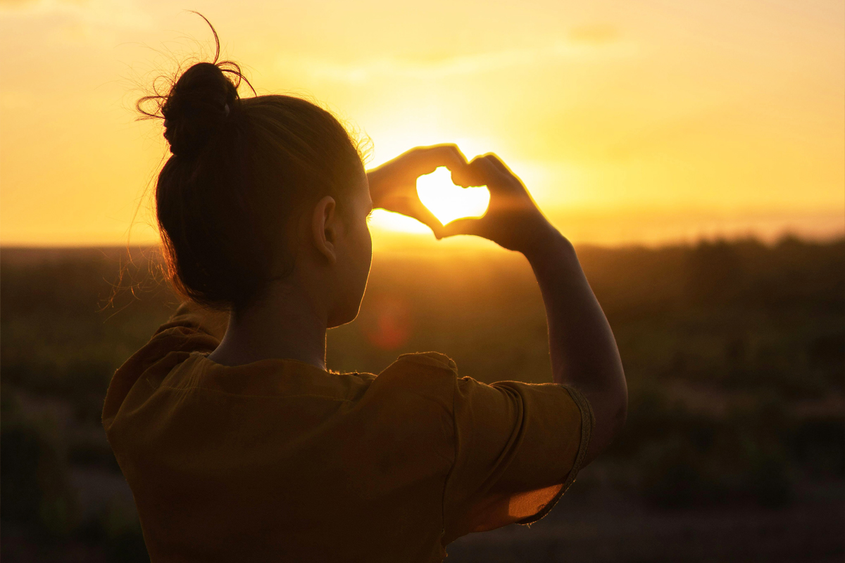 Womand doing heart shape with her hands